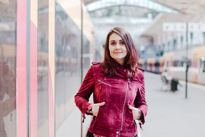 Portrait of beautiful young woman standing outdoors