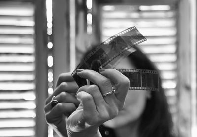 Close-up of woman looking film reel at home