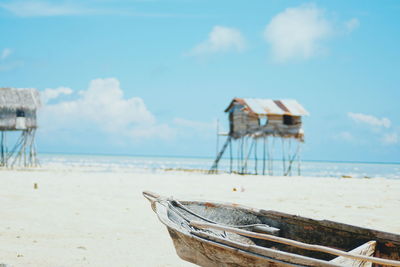 Lifeguard hut on beach against sky