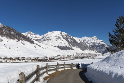 Scenic view of snowcapped mountains against clear blue sky