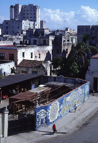 People walking on street against buildings in city