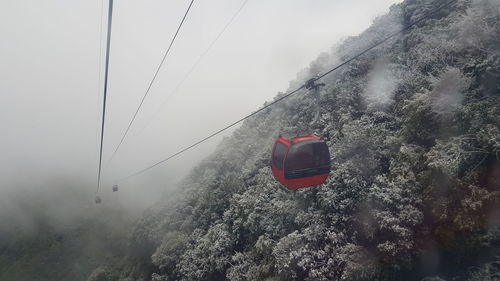 Overhead cable car on snow covered mountains