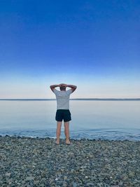 Rear view of man standing on beach