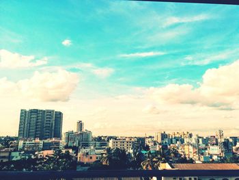 Cityscape against cloudy sky