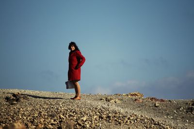 Full length of woman standing by railing