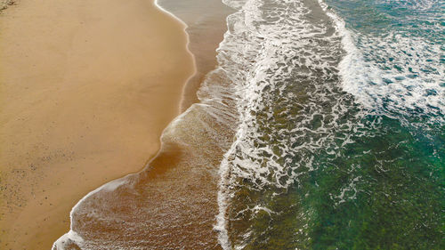 Aerial view of multicolored sea waves transparency