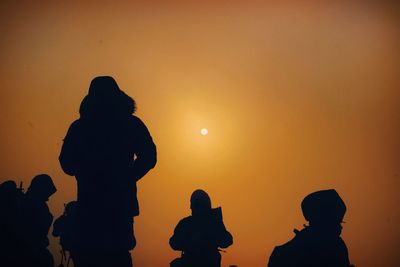 Low angle view of silhouette statue against sky during sunset