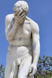 Low angle view of statue against clear blue sky