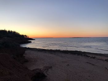 Scenic view of sea against clear sky during sunset