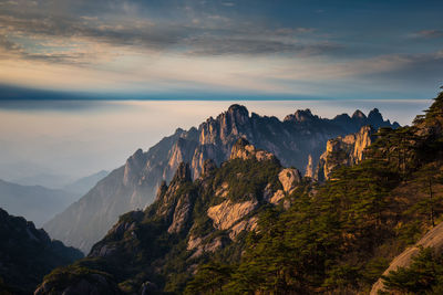 Scenic view of mountains against cloudy sky