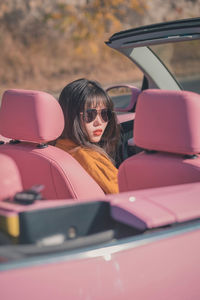 Portrait of young woman in car