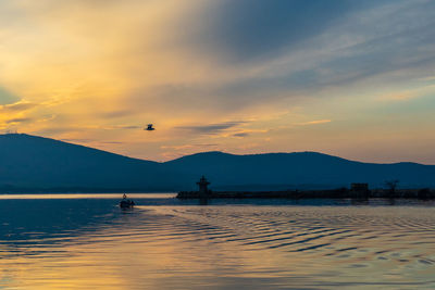 Scenic view of lake against sky during sunset