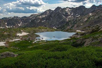 Scenic view of lake and mountains against sky