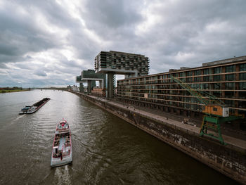 Bridge over river against cloudy sky