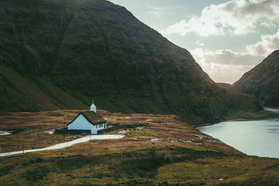 Scenic view of mountain and buildings against sky