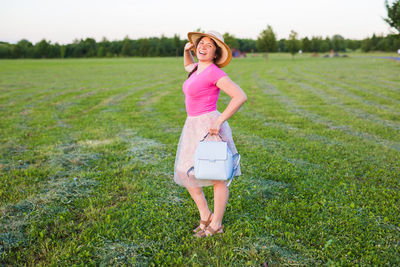 Full length of woman standing on field