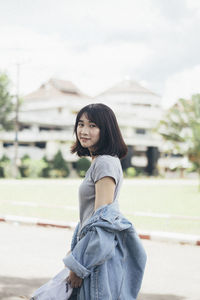 Portrait of young woman standing outdoors