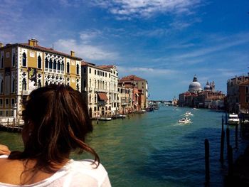 Rear view of woman overlooking calm river