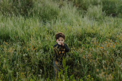 Portrait of boy standing on field