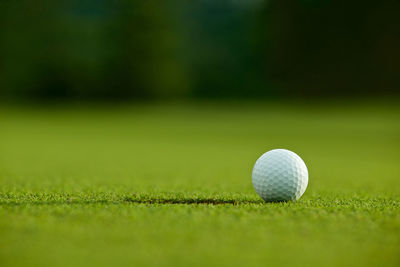 Close-up of golf ball on playing field