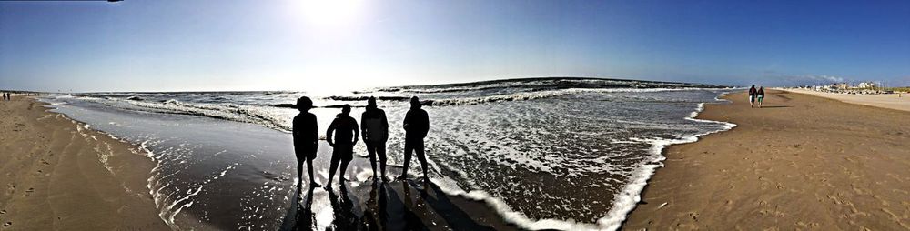 People on beach against sky