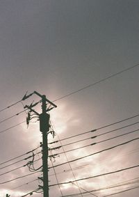 Low angle view of electricity pylon against sky