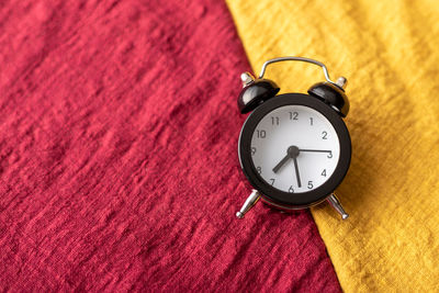 High angle view of clock on rug