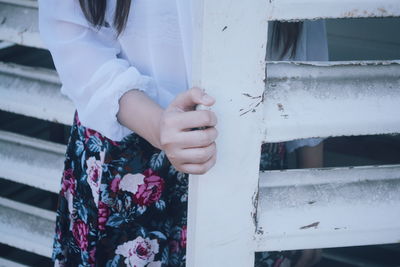 Midsection of woman standing near door