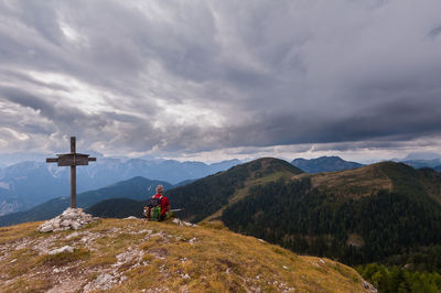 Man looking at mountain against sky