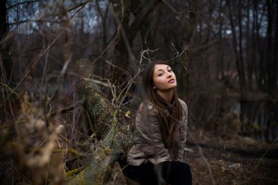 Young woman standing in forest