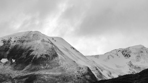 Scenic view of mountains against cloudy sky