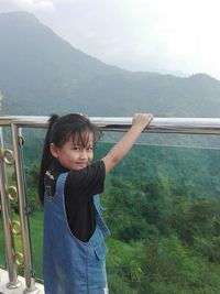 Portrait of woman standing on mountain