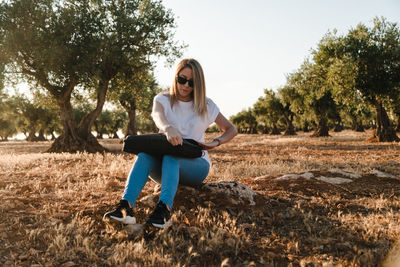 Woman sitting at olive orchard