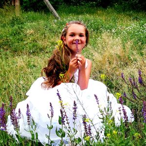 Portrait of happy girl in flower field