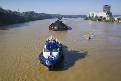 Coal barge pulled by tugboat on mahakam river