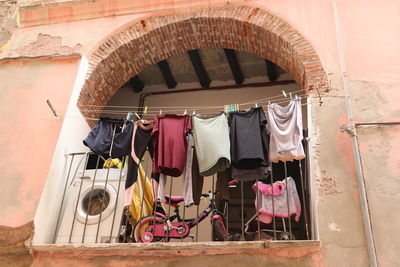 Low angle view of clothes drying against building