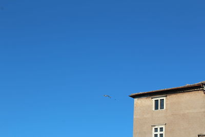 Low angle view of built structure against clear blue sky