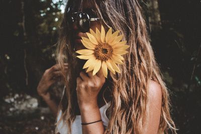 Close-up of woman holding flowers