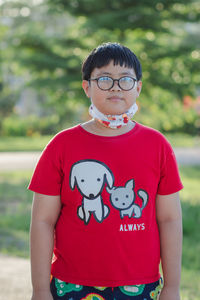 Portrait of smiling boy standing outdoors