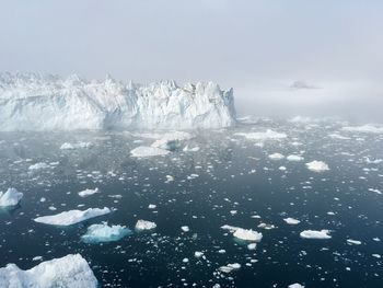 Frozen sea against sky