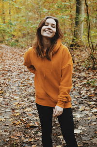 Portrait of smiling woman standing on land during autumn