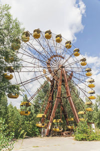 Low angle view of ferris wheel against sky