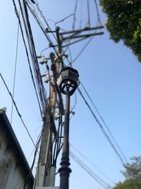 Low angle view of electricity pylon against sky