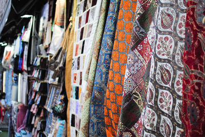 Close-up of textile hanging in market for sale