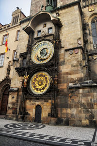 Low angle view of clock tower against buildings