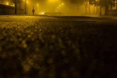 Mid distance of person walking on road at night