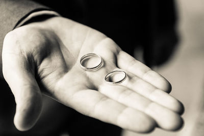 Close-up of man hand holding rings