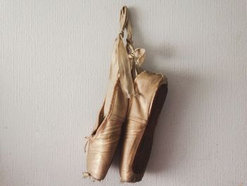 Close-up of ballet shoes hanging on wall