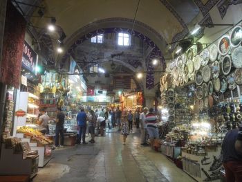 People in illuminated market at night