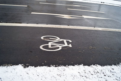 High angle view of bicycle lane sign on road during winter